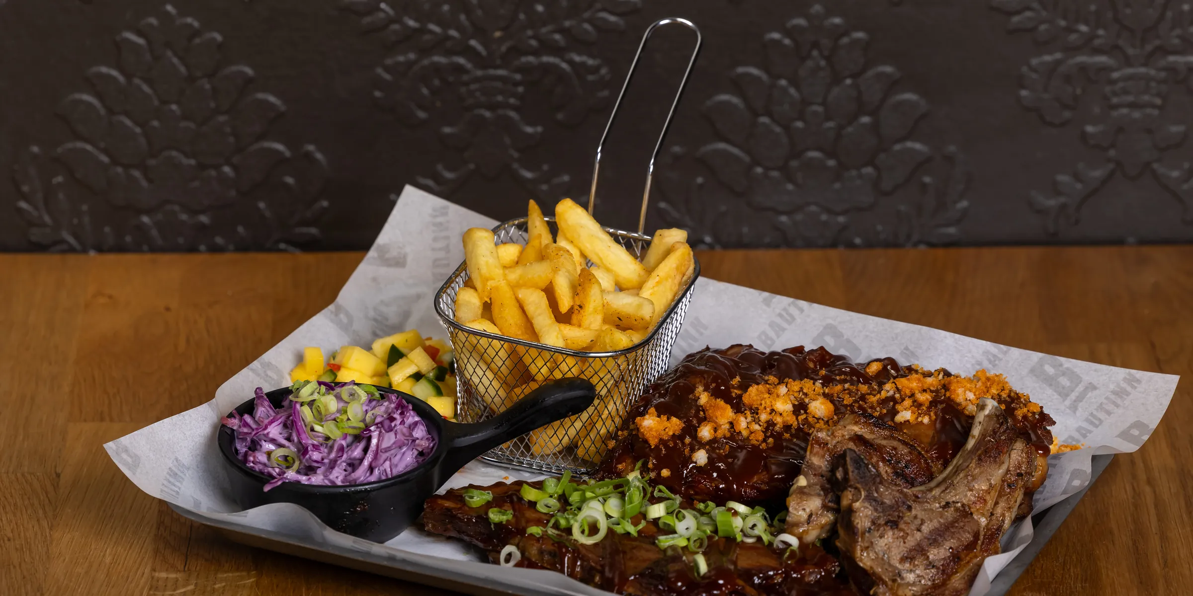 Ribs and a chop on a tray at Bautinn